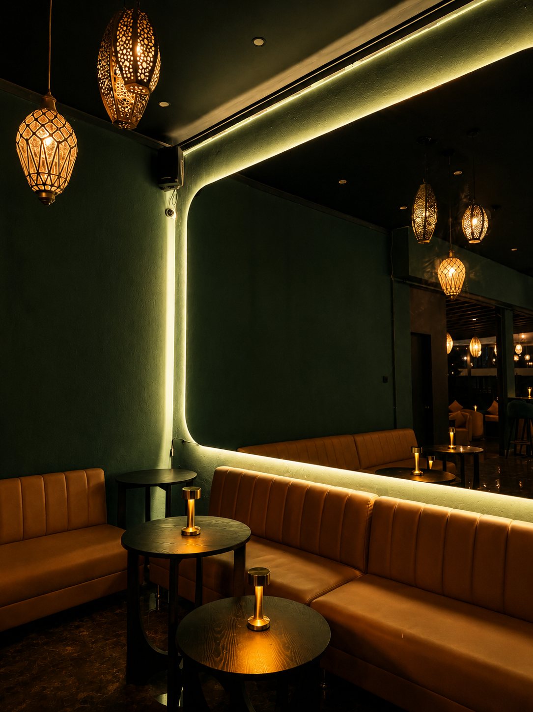 The emerald dining room, lit by brass lanterns